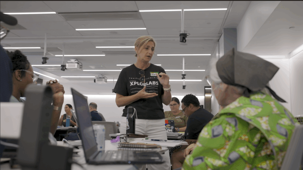 Kara Reeder engaged in conversation with other Xplorlabs Educator Fellows